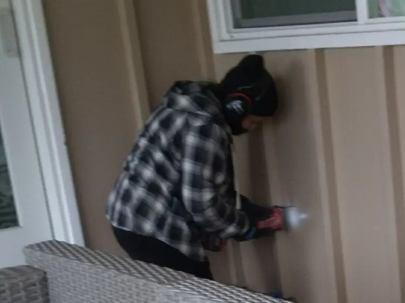 Professional electrician installing an exterior outlet in Cold Spring